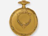 an image of a gold pocket watch with diamonds on the dial