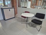 a small table and two chairs in a room