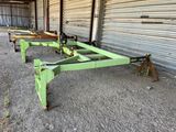 two green metal tables sitting in front of a metal building