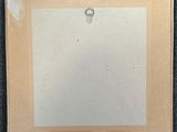 an image of a piece of paper with a ring on top of it