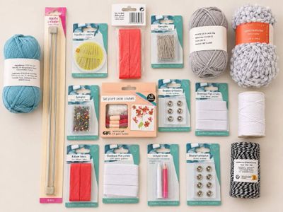a lot of yarn and crochet supplies laid out on a table