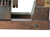 a wooden machine that is sitting on a white surface