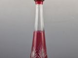 a red glass decanter on a grey background with a gray background