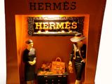 two mannequins in a display case in a store
