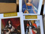 four books in a box with a picture of a king and queen on them