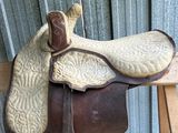 a saddle that is sitting on top of a wooden chair