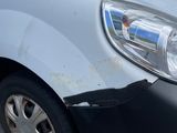 a car that has been damaged and is parked in a parking lot