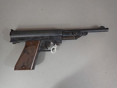 a gun that is sitting on a table with a key in it