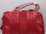 a red leather handbag with a rope on the handle