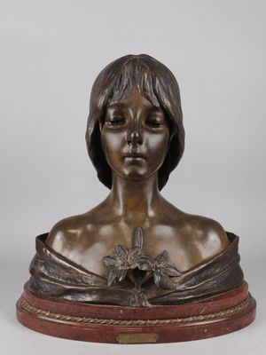 a bronze bust of a woman with a flower in her hair