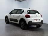 the rear of a white citrole parked inside of a building
