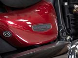 a close up of a red motorcycle parked on the street