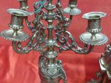 a silver candelab that is sitting on a red cloth