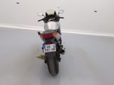 a motorcycle parked in a room with a number plate on the back of it