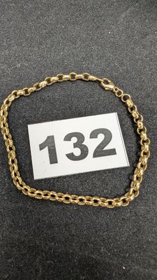 un gros plan sur un bracelet à chaîne en or portant le numéro 1232