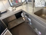a stainless steel sink in the middle of a kitchen