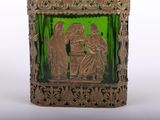 a green glass vase with a picture of a man and a woman on it
