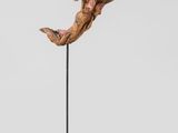 a sculpture of a person jumping in the air on a black stand