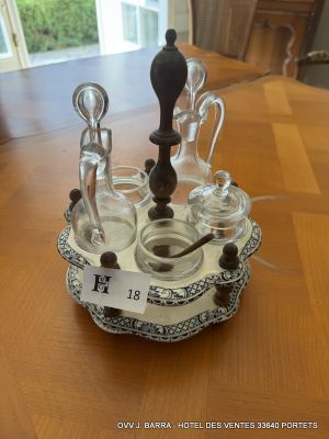 bottles and spoons on a tray on a table in front of a window