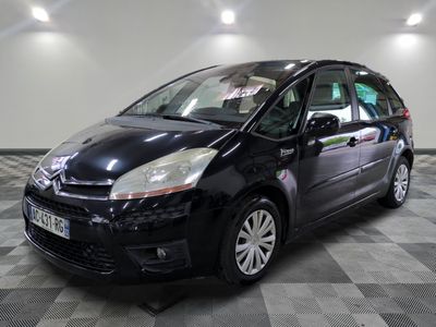 a picture of a small black car parked in a garage