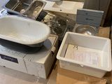a lot of items that are sitting on the floor in the bathroom
