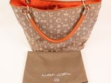 a close up of a handbag with a bag in front of it