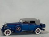 a toy car that is sitting on a white surface