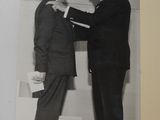 black and white photograph of two men in suits standing next to each other