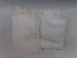 two bags of flour sitting on a white surface