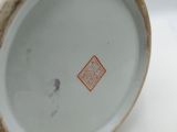 a close up of a vase on a white surface