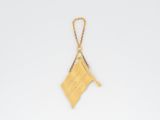 an image of a book with a gold bookmark hanging from it ' s cover