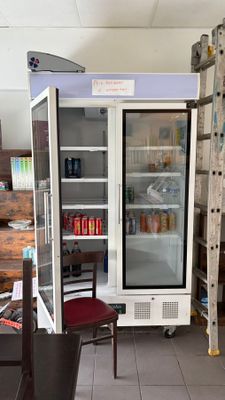 a refrigerator that is sitting in the middle of a room