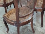 several wooden chairs are lined up in a row in a room