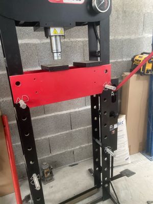 an image of a hydraulic press in a garage