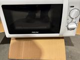 a microwave that is sitting on a cardboard box