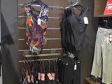 a display of clothing in a clothing store with clothes on hangers