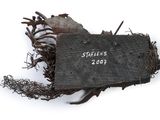 a piece of wood with a sign attached to it