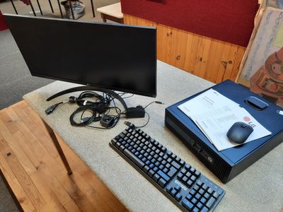 un bureau équipé d'un ordinateur, d'un clavier, d'une souris et d'un écran