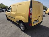 the back end of a yellow van parked in a parking lot