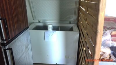 a small refrigerator in the corner of a room