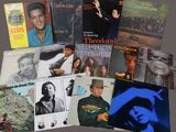 many different album covers on the table together