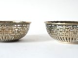 pair of silver plated bowls on a white background