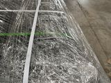 many rolls of wire wrapped in plastic in a warehouse