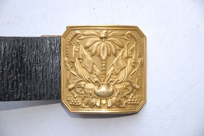 a gold belt buckle with a picture of a bird on it