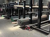 many different types of steel pipes in a warehouse