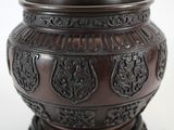 a brown vase that is sitting on a table