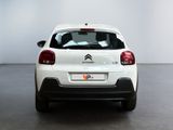 the rear of a white citrole parked in a white room