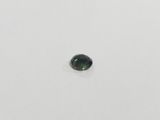a close up of a green tourmaline stone on a white surface
