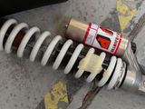 a close up of a coil and a can of paint on the ground