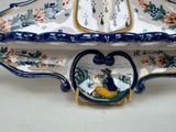 a decorative bowl with a bird on it on a table